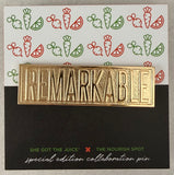Gold 'REMARKABLE' pin 